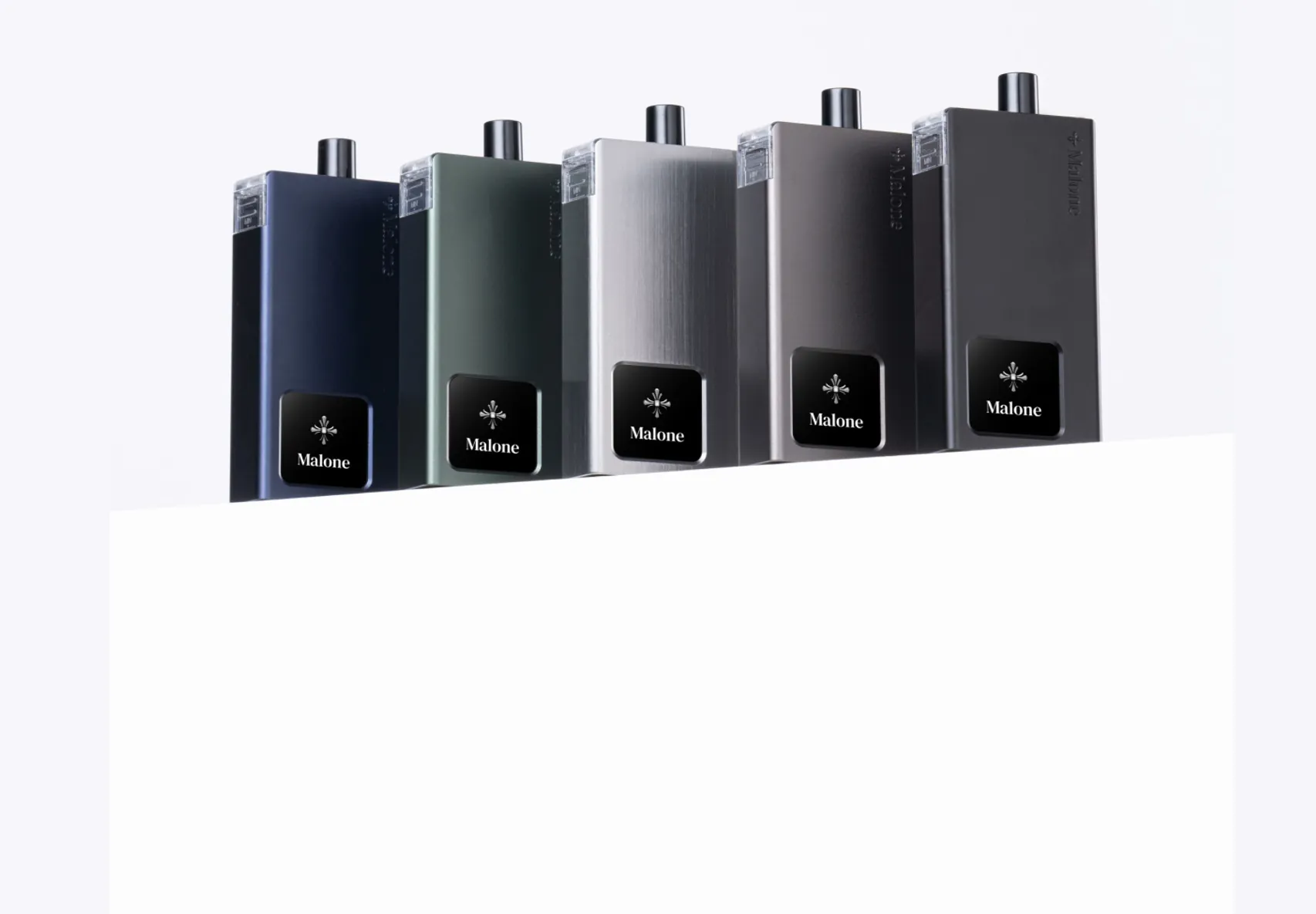 Five MALONE pod systems in navy, dark green, silver, grey and black, lined up on a pale studio background